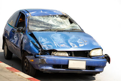 Close-up of damaged car in city