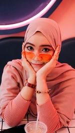 Portrait of young woman sitting outdoors