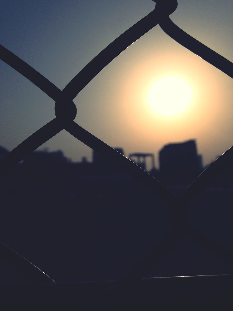 sun, sunset, metal, silhouette, sunlight, sky, chainlink fence, protection, fence, safety, sunbeam, lens flare, orange color, security, connection, built structure, metallic, no people, outdoors, nature