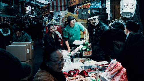 People at market stall in city