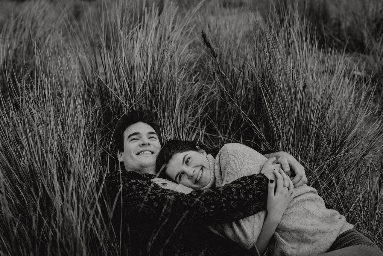 two people, togetherness, grass, emotion, men, happiness, child, women, lying down, leisure activity, childhood, people, relaxation, smiling, portrait, males, boys, plant, bonding, positive emotion, couple - relationship, outdoors
