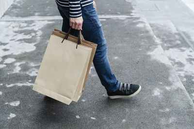 Low section of person standing on road