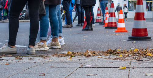 Low section of people standing on street