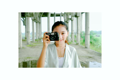 Portrait of woman photographing
