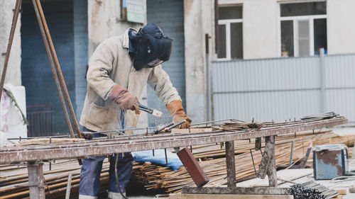 Welder welding at construction site