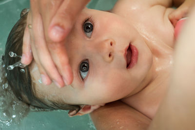 Close-up portrait of baby boy in bathtub