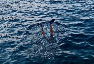 Low section of man snorkeling in sea