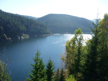 Scenic view of lake and mountains against sky