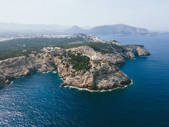 High angle view of sea and mountains against sky