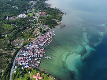 High angle view of townscape by sea against sky
