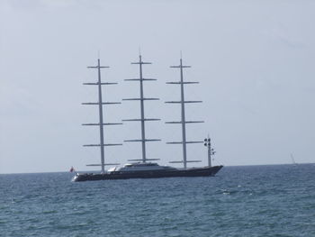 Ship sailing on sea against clear sky