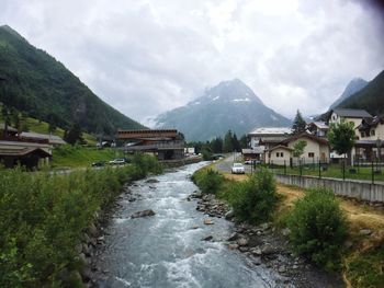 Scenic view of village by houses against sky