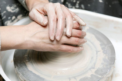 Midsection of person working on potter wheel