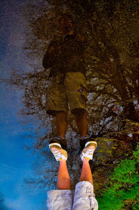 Low section of man wearing shoes