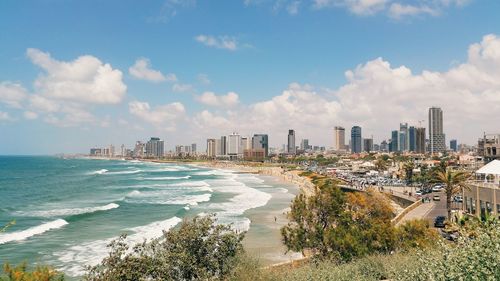 Scenic view of sea against sky in city