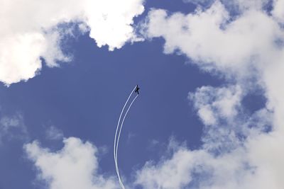 Low angle view of airplane flying against sky