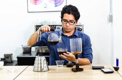 Young man in glasses on table