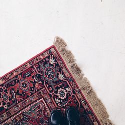 Low section of man standing on rug at home