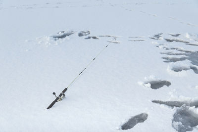 High angle view of people skiing on snow covered field