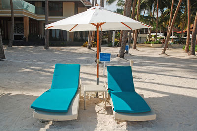 Deck chairs on swimming pool