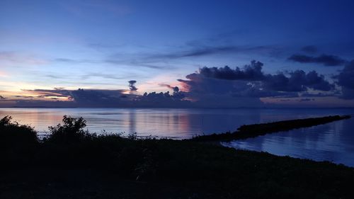 Scenic view of lake against sky during sunset