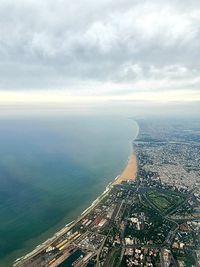 Aerial view of buildings and sea against sky