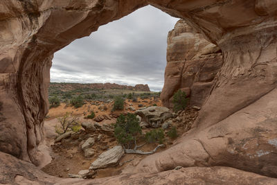 View of rock formations against cloudy sky