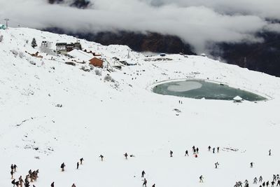 Aerial view of people on snow covered mountain