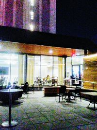 Chairs and tables in restaurant at night