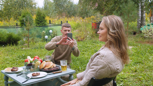 Young woman in drinking glasses on table