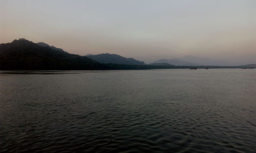 Scenic view of lake against sky at sunset