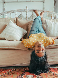 Portrait of smiling boy on bed at home