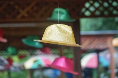 Close-up of illuminated lighting equipment hanging at store