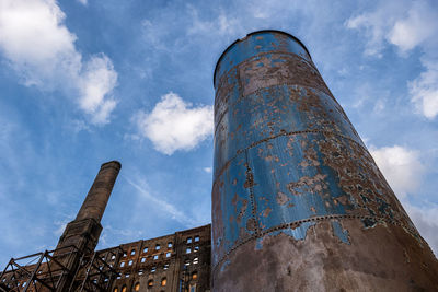 Low angle view of old factory against sky