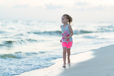 Cute girl running at seashore