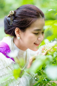 Portrait of a young woman with red flower