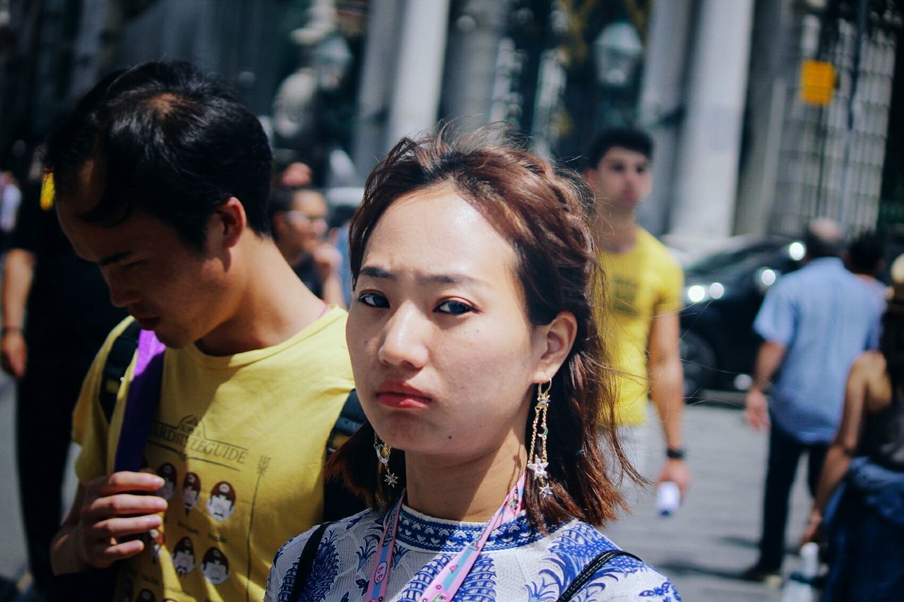 headshot, real people, portrait, incidental people, focus on foreground, lifestyles, city, leisure activity, people, young adult, women, street, adult, casual clothing, front view, two people, looking, close-up, young men, hairstyle, contemplation