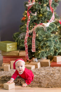 Full length of girl with christmas tree