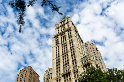 Low angle view of buildings against cloudy sky