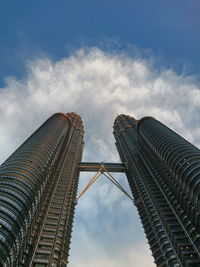 Low angle view of buildings against cloudy sky