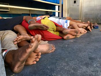 Low section of homeless children sleep on footbridge