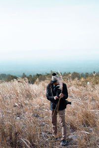 Man standing on field against clear sky