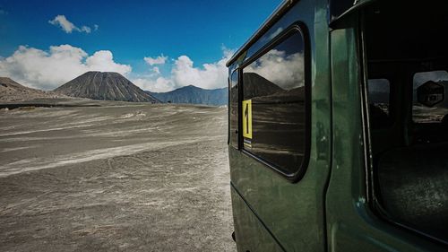 Bus on mountain against blue sky