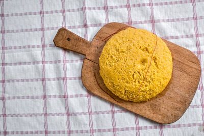 Hot steaming polenta on a old wooden board on the table