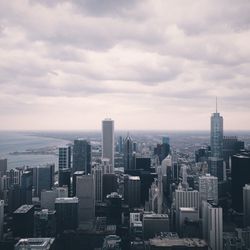 View of cityscape against cloudy sky