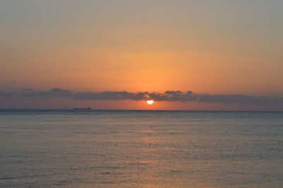 Scenic view of sea against romantic sky at sunset