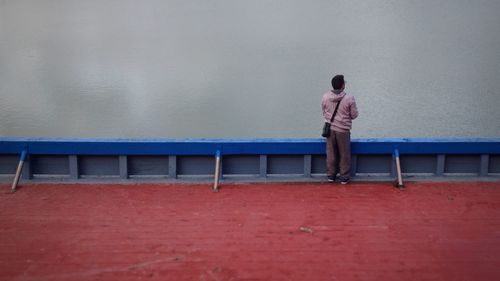 Full length of woman standing by railing