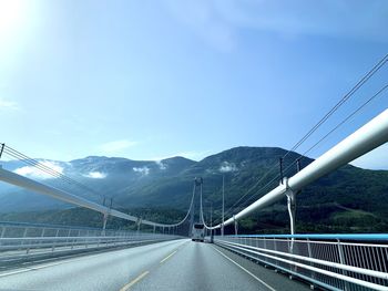 Road by bridge against sky