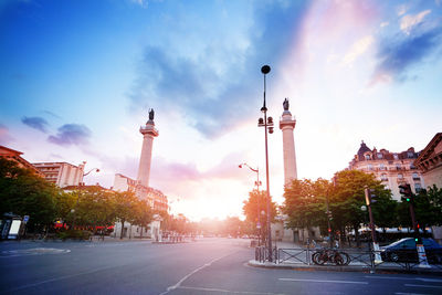 Street with buildings in background at sunset