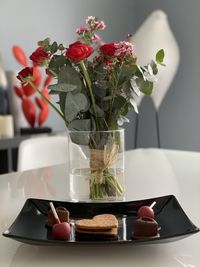 Close-up of roses in vase on table